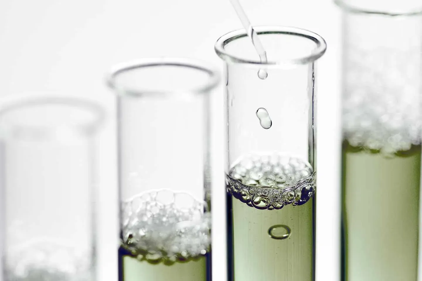 Green extracts in glass test tubes
