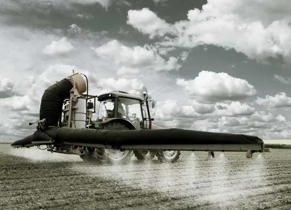Tractor spraying a field